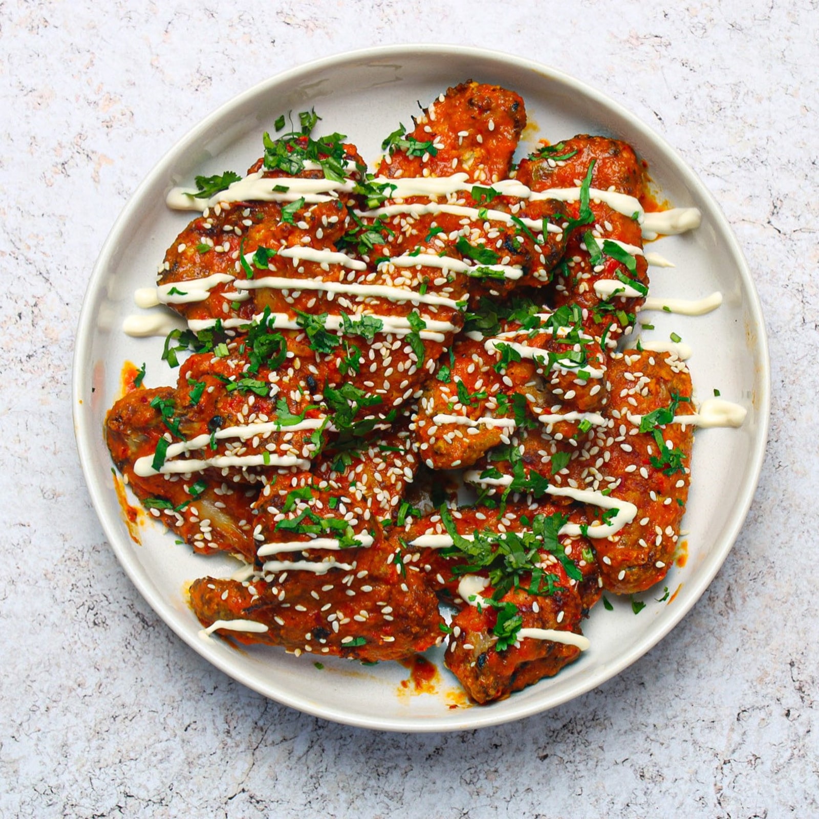  Plate of buffalo sauce coated buttermilk chicken wings 